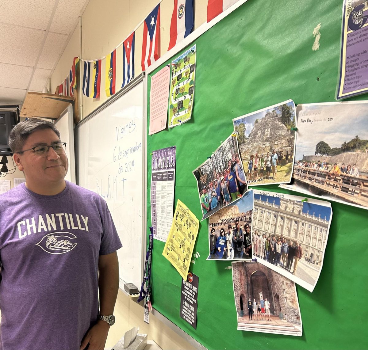 Spanish teacher Alejandro Torres looks at his old travel photos in the classroom. 