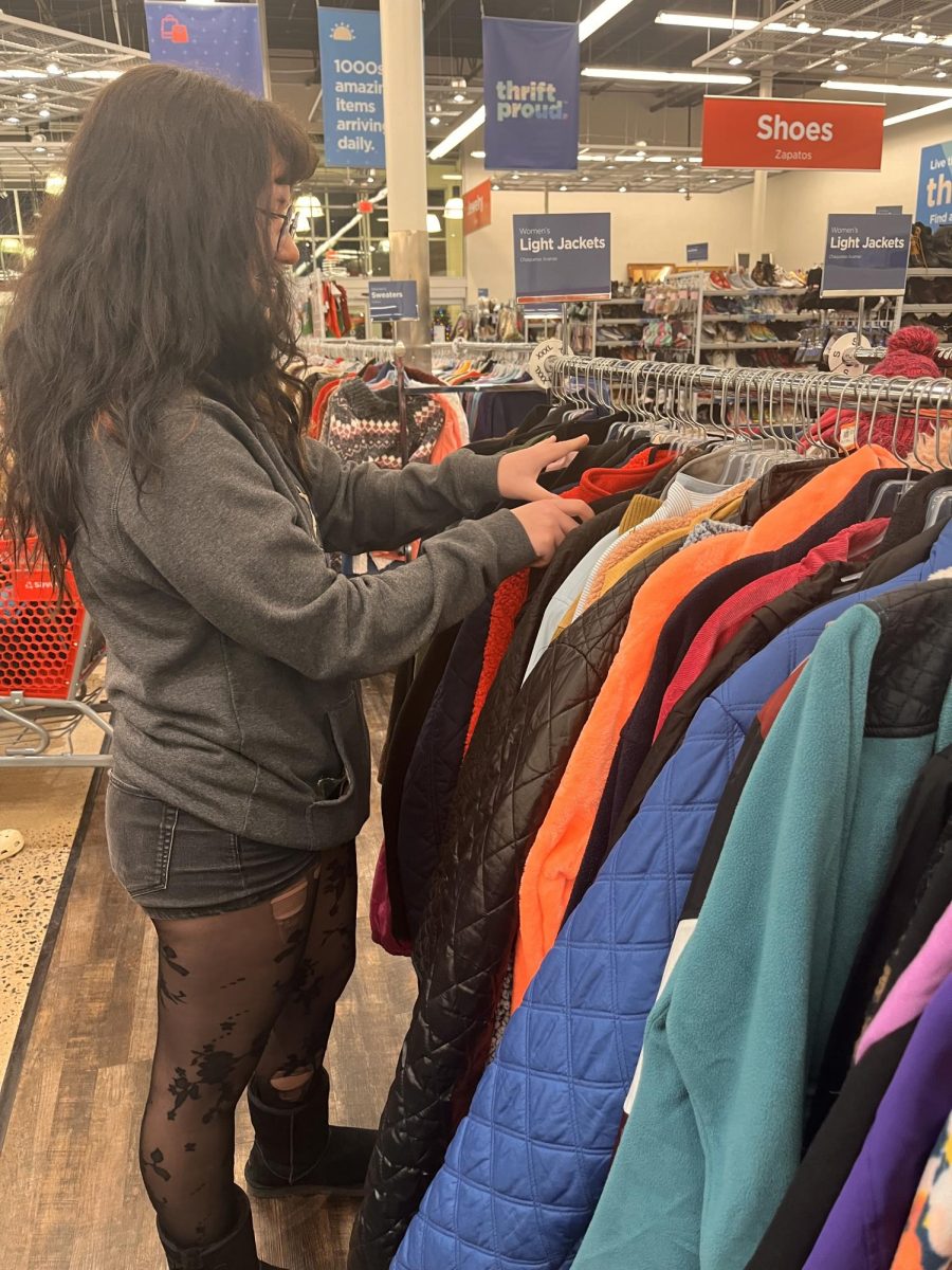 Ellie Russell comes to visit the new Savers store in Fair Lakes and is going through a rack of clothes. “I come thrifting often; “it’s a fun way to spend time with your friends,” Russell said. 
