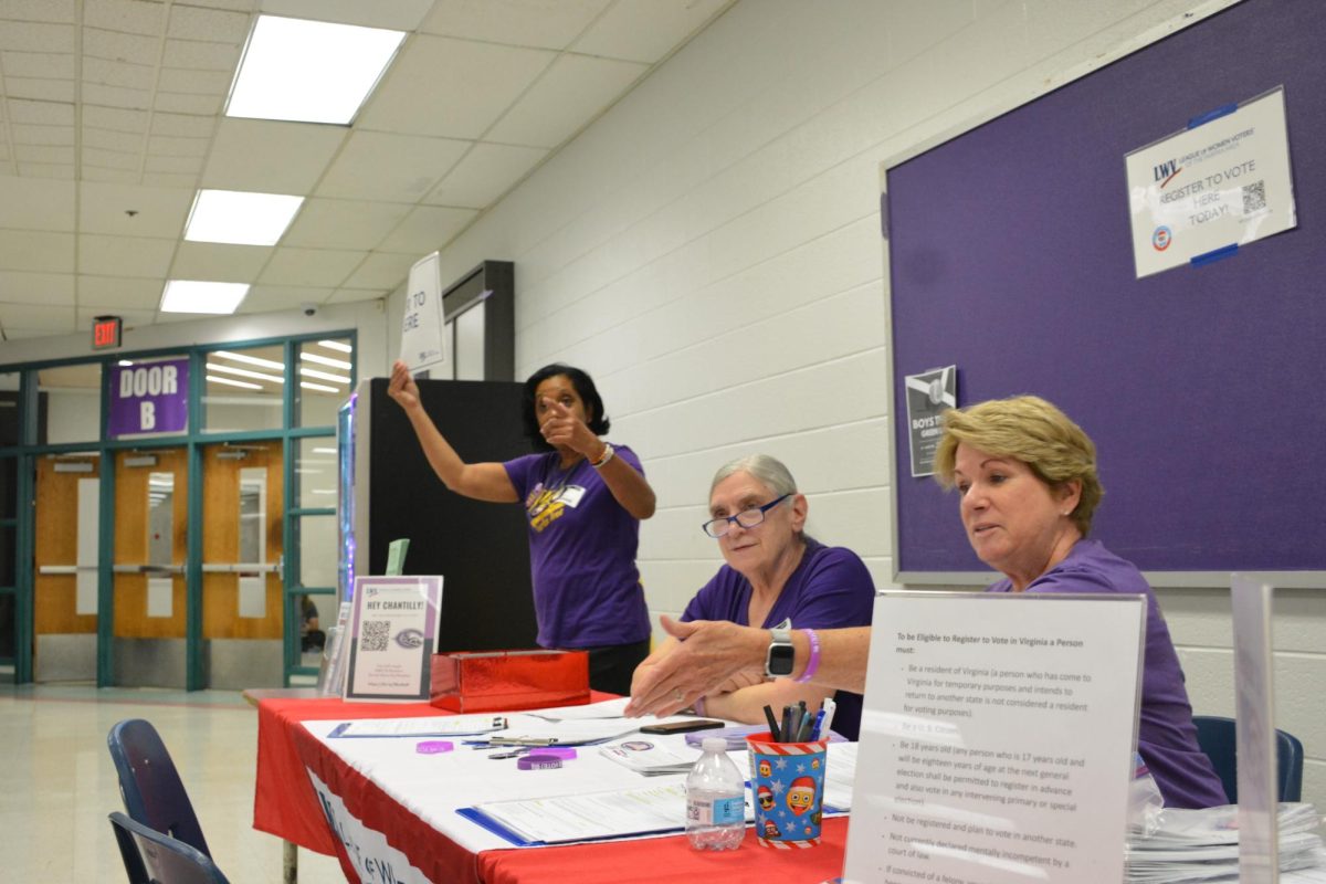 At the CHS cafeteria, Camille Milks, Ruth Grubb and Dorothy Chiaratona from The League of Women Voting advocate their program to help students register to vote.