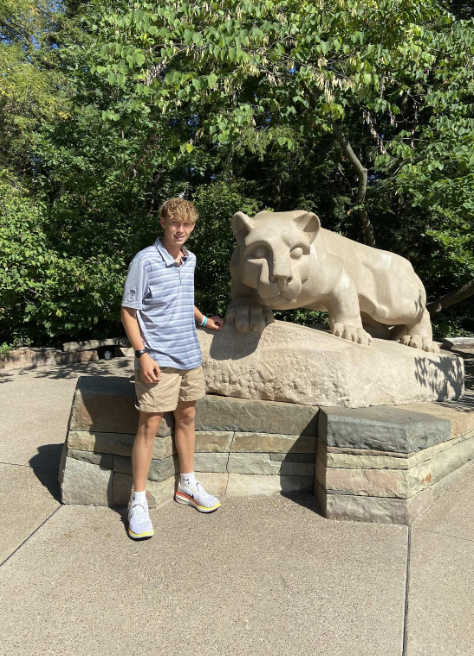 Senior Tristan Thurnysan posing with the Penn State lion after a visit.