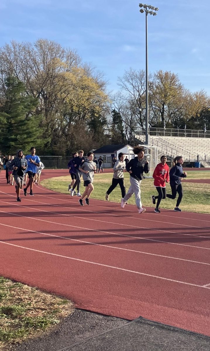 Winter track athletes run warm up laps around the track at practice on Nov. 25. 