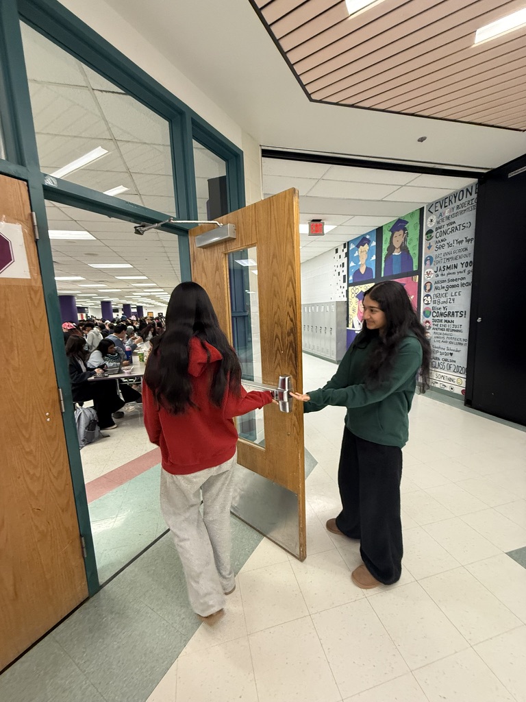 Sophomore Manasvi Singh opens the door to the cafeteria for sophomore Amogha Gummadivalli, showing a small act of kindness during lunch.
Photo taken by Athula Cheboli