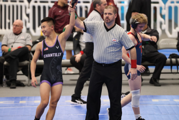 Junior Carter Shin is declared victor in a meet on Dec. 7 against Gainesville High School in which Chantilly won 53-9.