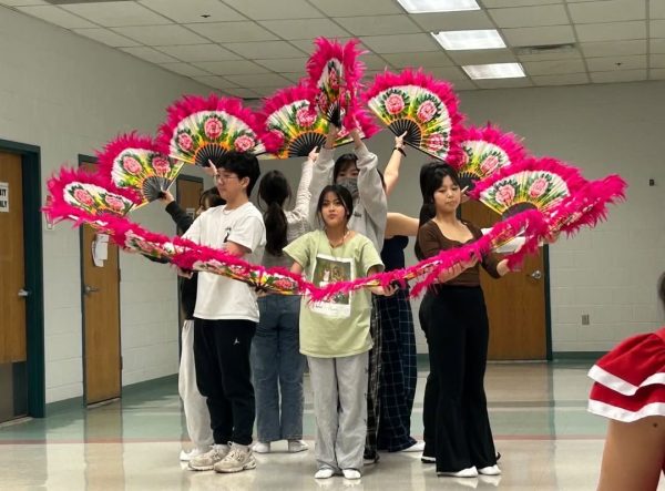 On Dec. 12, members of the Korean Club perform a traditional fan dance during a rehearsal. 
Photo by Rachel Neathery
