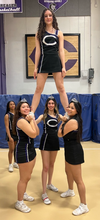 Freshman Angela Brezi, senior Amy Flores Cortes, senior Leena Saim and senior Arianna Reyes Prado stunt at Senior night on Fri, Jan. 24.