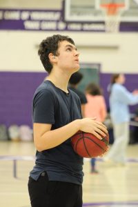 Freshman athlete Gavin Hilbert prepares to shoot a basket at unified basketball practice on Feb. 13. Photo used with permission of Dylan Hancock.