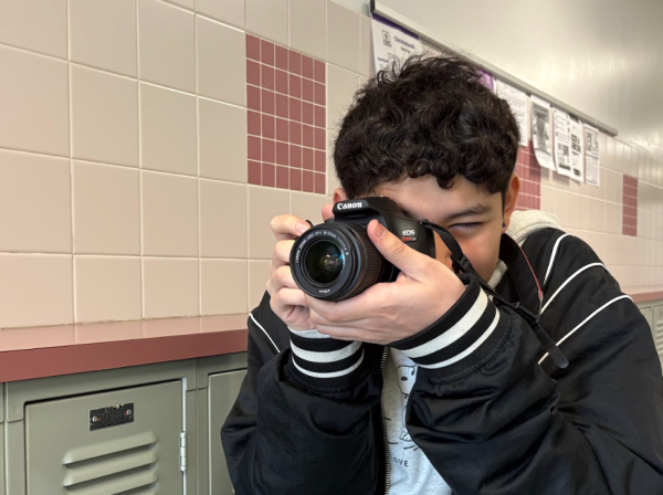 Yearbook staffer sophomore Owen Guzman takes a photo on March 3. Before his work is published, it will be reviewed by multiple levels of student leadership and yearbook adviser Luc Nguyen, but the book does not go through prior review.