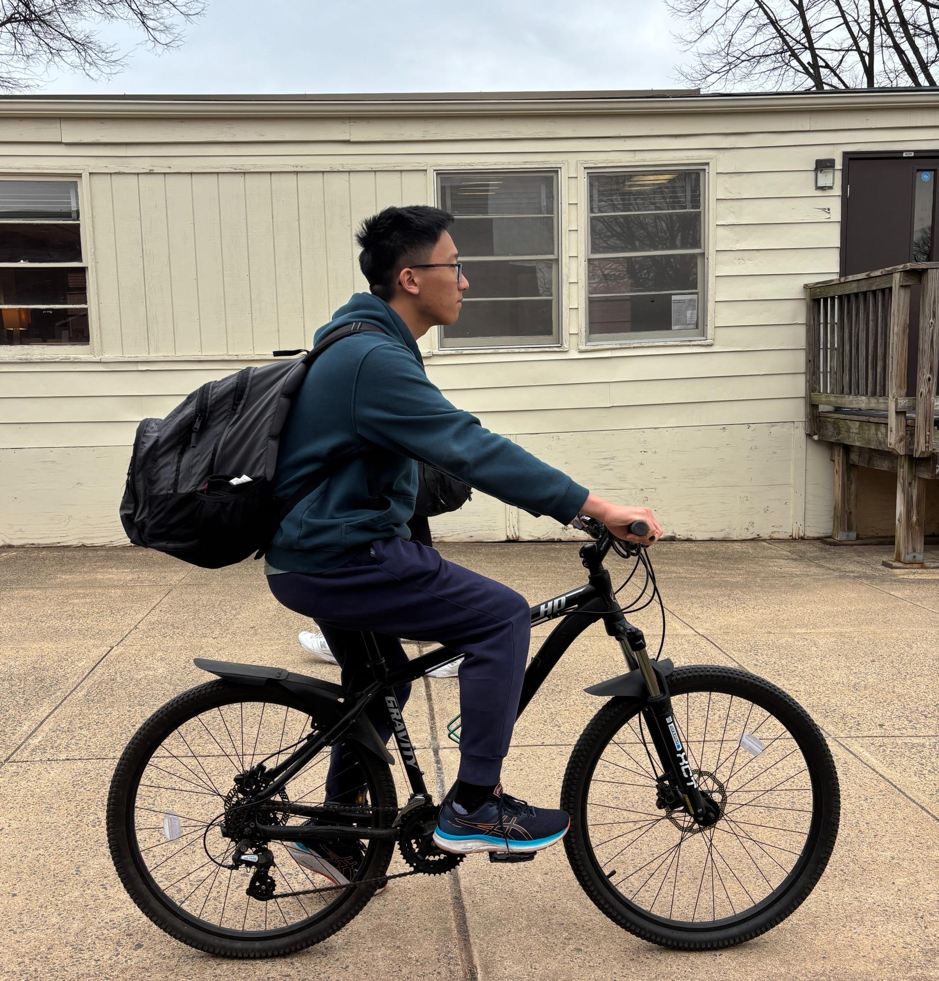 As the bell rings for dismissal, senior Jason Choo pedals through school grounds, heading towards home as another school day ends.

