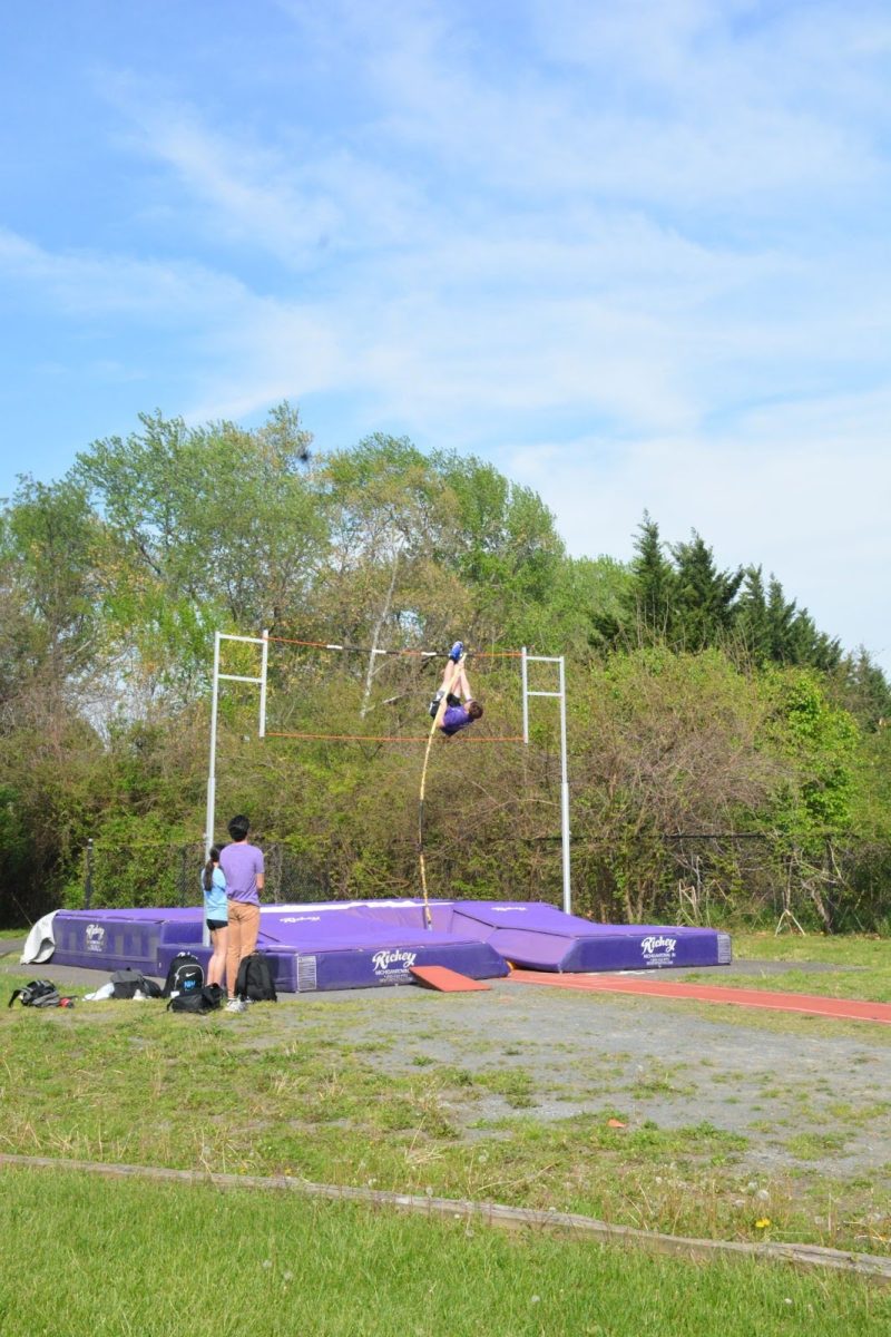 Senior Trent Saben practices pole vaulting with coach James Steck watching on April 21.
