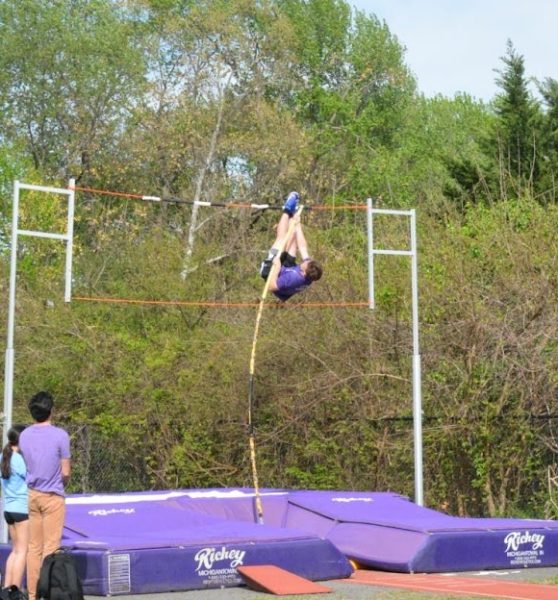 Senior Trent Saben practices pole vaulting with coach James Steck watching on April 21.