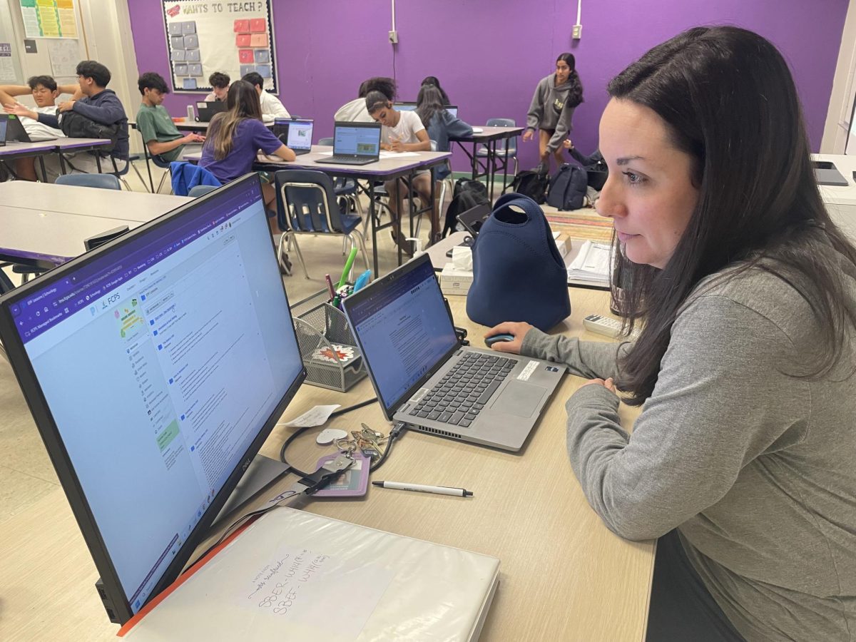 Teacher Katherine Reinfried plans for upcoming self-directed economics and personal finance summer courses.
