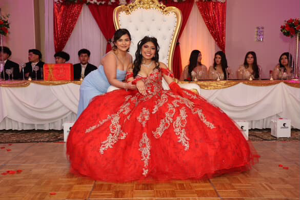 Freshman Leydi Sandoval Ramirez displays a red ball gown with gold embroidery, styled in loose curls, a tiara and soft glam makeup on Mar 22 photo courtesy of AleLuna Studio LLC.
