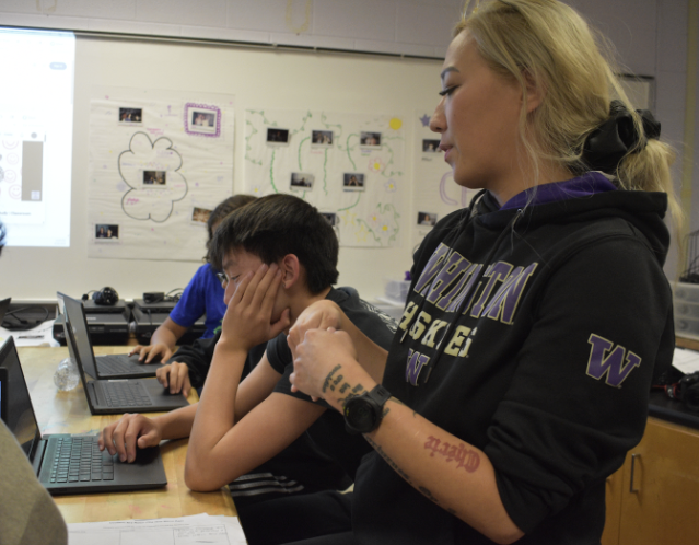 Photography teacher Alex Kang explains the nature of taking photos to freshman Connor Li on Aug 28. Photo by Amanda Yesin 