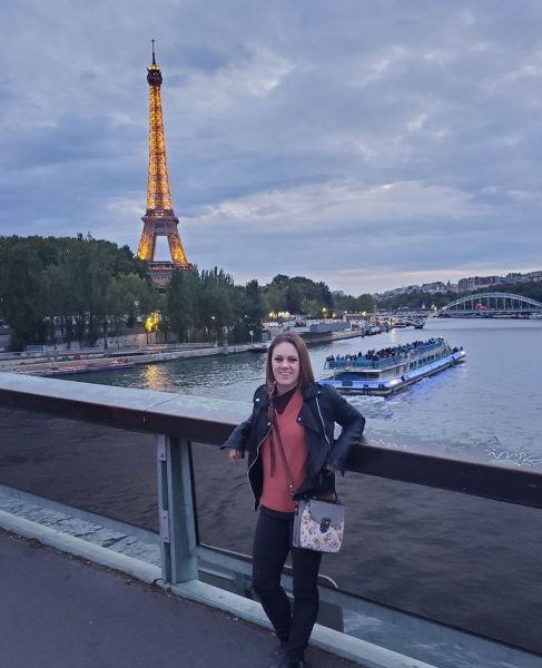 French teacher Hannah Hughes
class on Aug. 26. Photo by Saaya Patel.			stands in front of the Eiffel Tower during her trip to France in the summer of 2019. Photo used with permission of Hannah Hughes