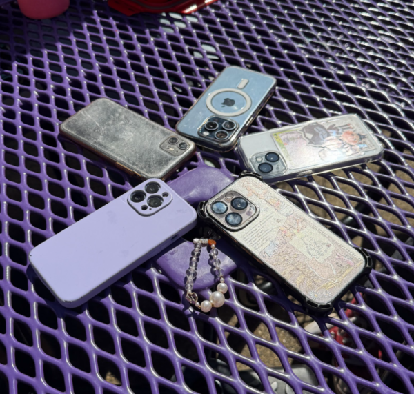The cellphones of multiple students lay face down on a table during lunch on Oct. 9. The new policy only allows students to use their phones during their lunch break.