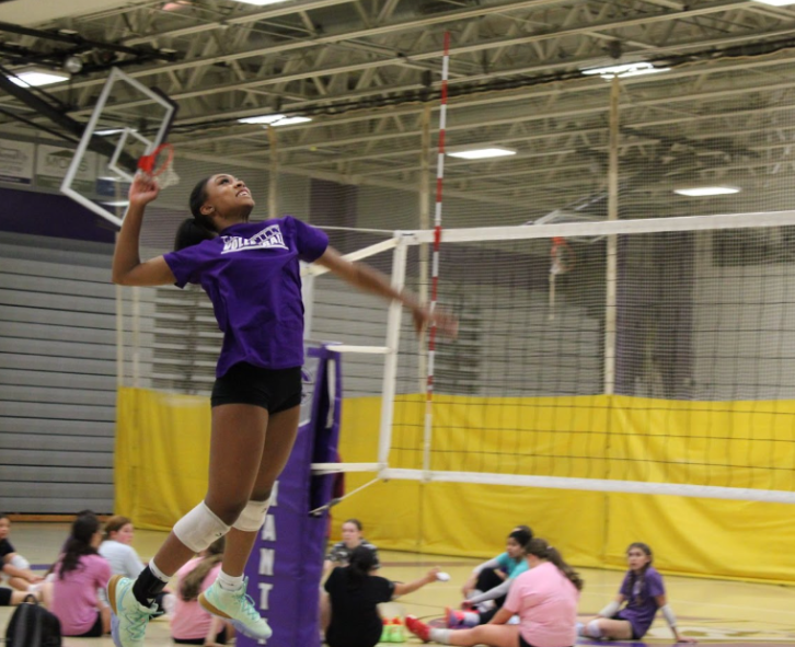 Junior Skyler Riley jumps to spike the ball on Oct. 9. 