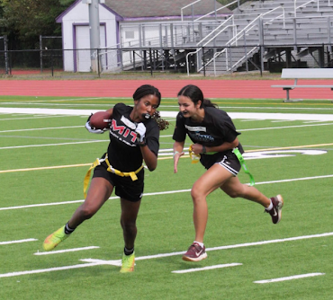 Sophomore  Ryan Herbert protects the ball against junior Jenna Paige during flag football tryouts on Sept. 23. Herbert made the team but Paige did not. Photo used with permission of Andre Roberts(@graphics_bydre on Instagram).