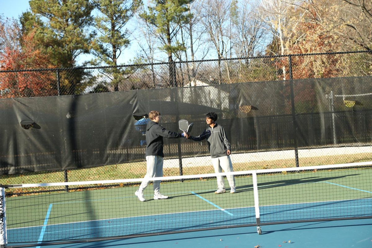 Gilbert and Sharma tap paddles after they defeat their opposing teammates 5-0 on Nov. 11. 