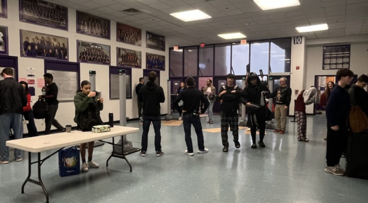 Students get past the weapon detection scanners on Dec. 18. 
