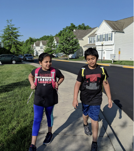 Caption:  Athula and Athri walk to the bus stop together at age 9 on May 9, 2018.
Photo used with permission of Venkat Cheboli.
