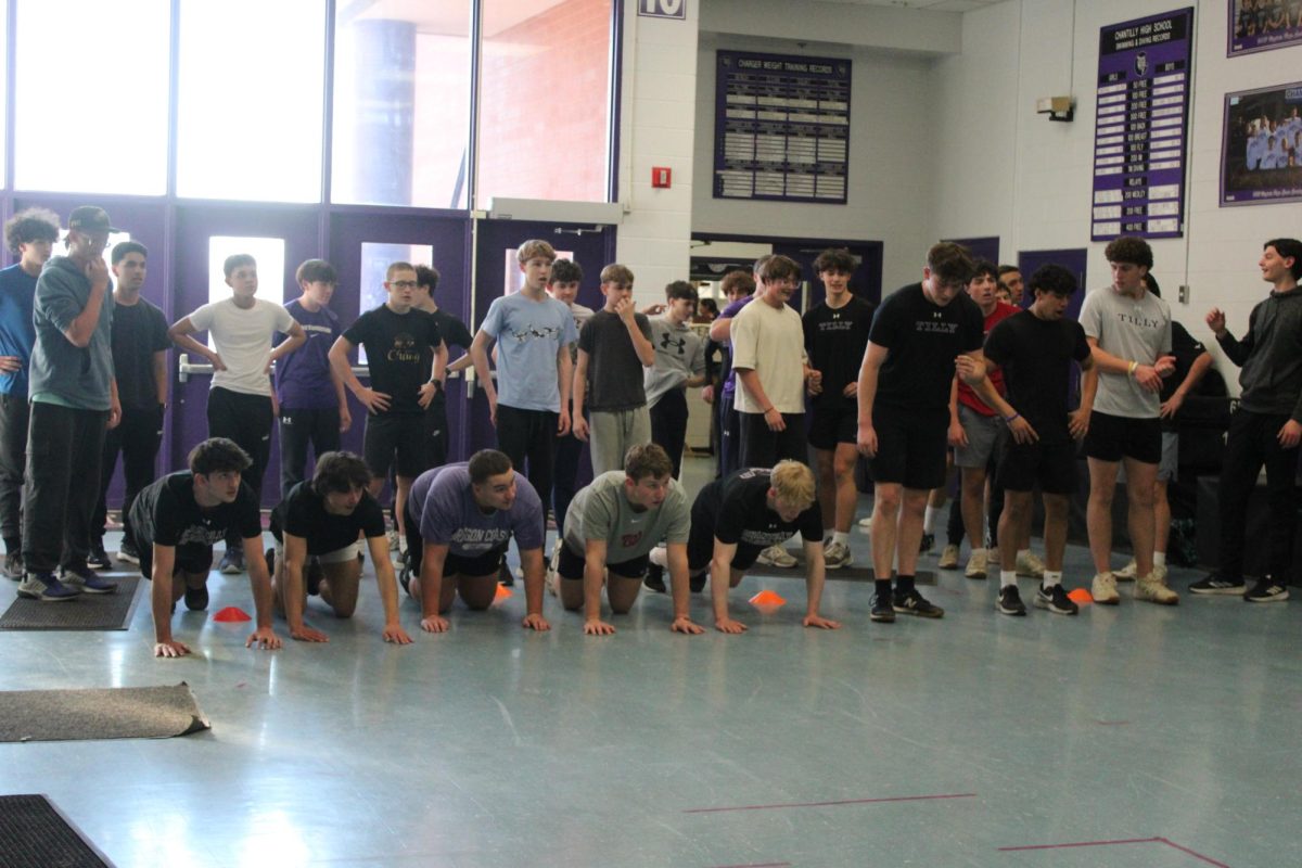 The baseball team hopefuls get ready for tryouts practices drills during their green day in the gym lobby on Feb. 11.