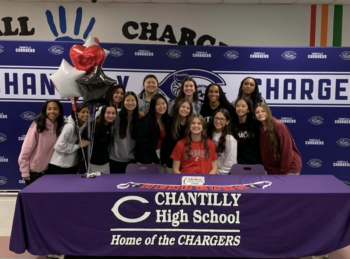 Senior Julia Horan, teammates and friends celebrate her signing for the University of Cincinnati on Nov. 15. “Julia is one of the most motivated and driven people I know,” senior Sarah Kim said. “She is always bringing her best effort on the court and, personally, she is very kind and understanding as a friend, teammate and captain. She has grown so much in the sport and it has been a privilege to watch her progress and also play with her.” Photo used with permission of Cindy Horan.