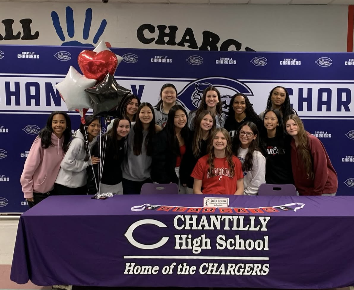 Senior Julia Horan, teammates and friends celebrate her signing for the University of Cincinnati on Nov. 15. “Julia is one of the most motivated and driven people I know,” senior Sarah Kim said. “She is always bringing her best effort on the court and, personally, she is very kind and understanding as a friend, teammate and captain. She has grown so much in the sport and it has been a privilege to watch her progress and also play with her.” Photo used with permission of Cindy Horan.