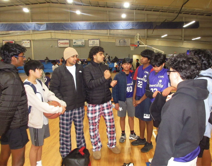 Junior Pranav Adivi, in the middle, and his friends gather at the recreational center after a basketball game on Jan. 4, 2025. Photo by Athula Cheboli.