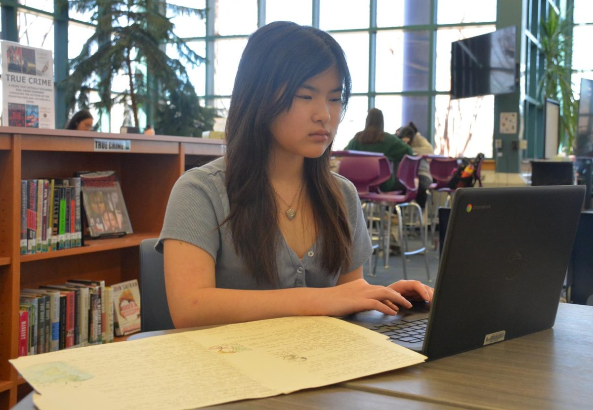 Freshman Shino Tanaka works on homework on Mar. 9 for AP Human Geography, a course often accepted as an elective credit by colleges, if the exam is passed with a score of 3 or above.