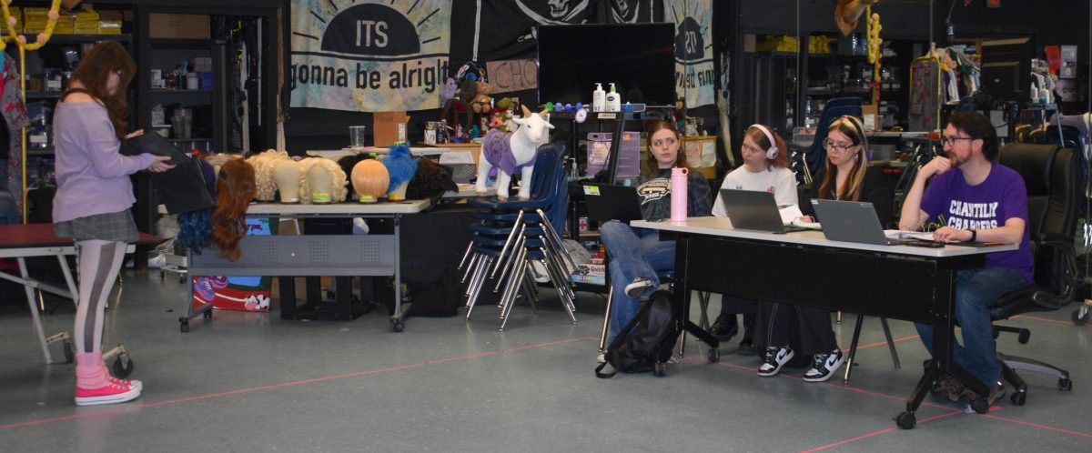 On March 4, sophomore Lorelei Doran runs through the script with senior Brooke Ciriacks, junior Allison Rolander, junior Macie Brooks and director Andrew Shaw.