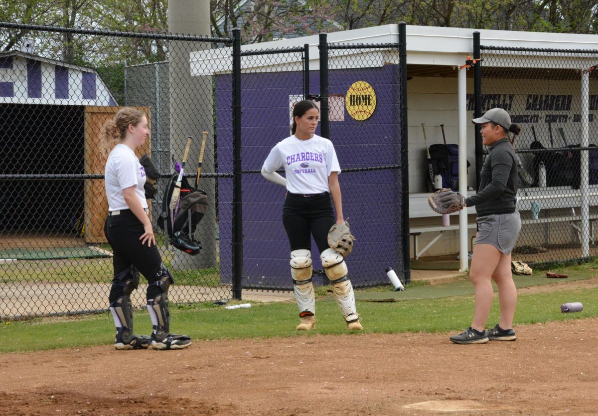 Freshman Sunny Moring and junior Olivia Shultis get instruction from their coach on April 13. 