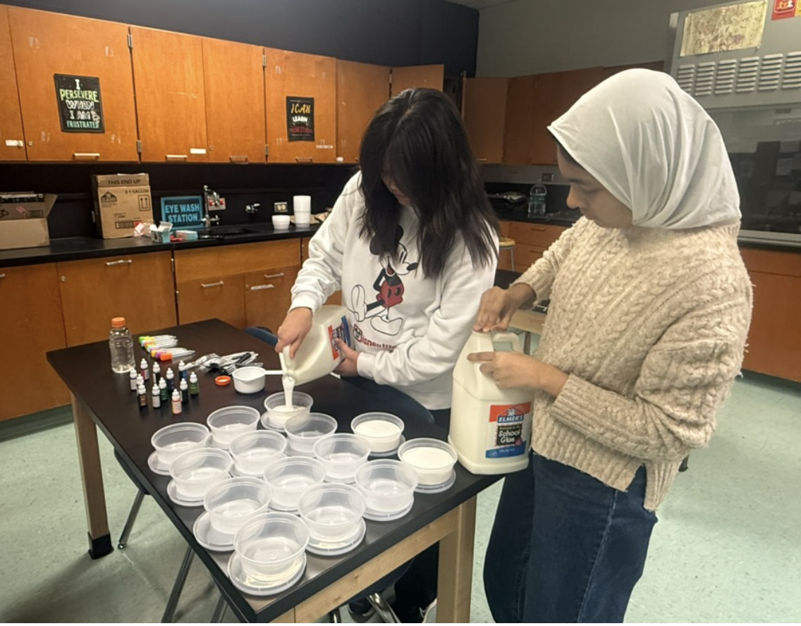 Senior Rubayyi Saaim and sophomore Aria Huaman prepare slime kits for Women in Science club for their lesson on slime and its benefits for stress on April 9.

