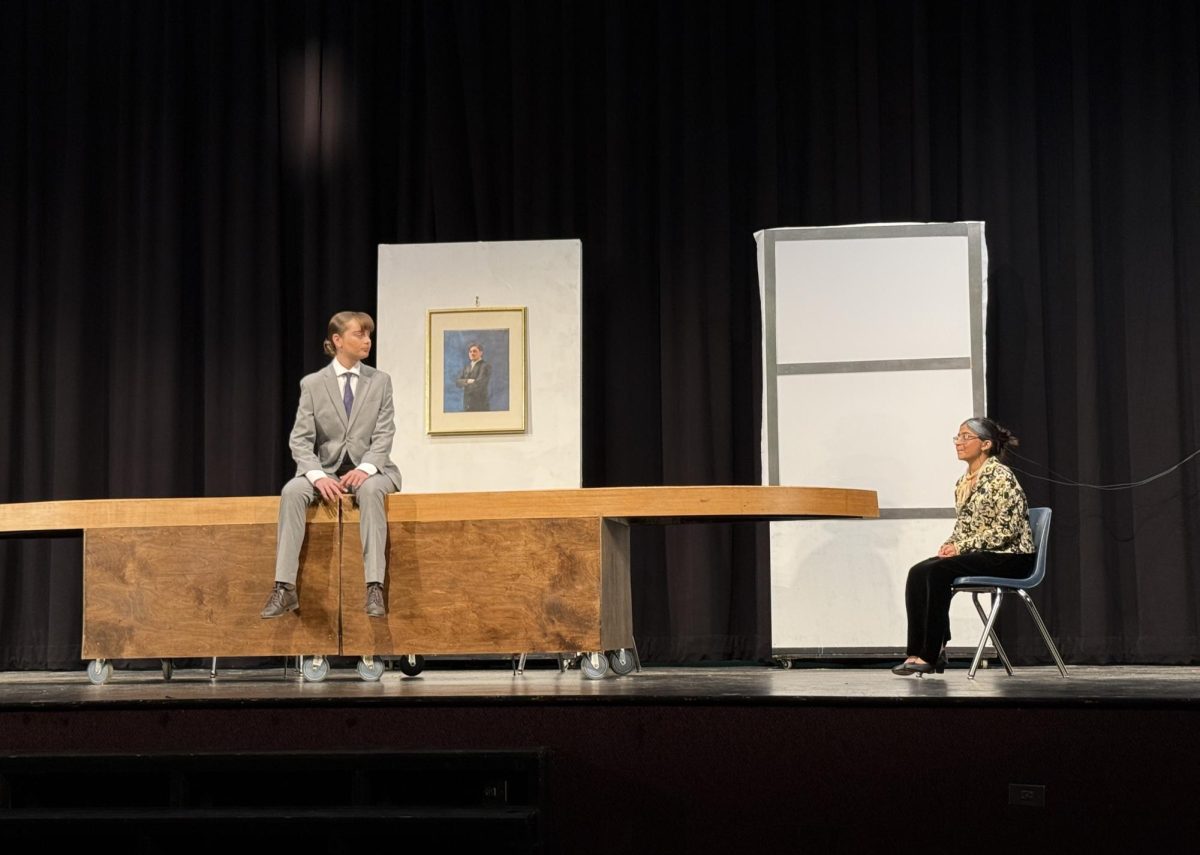 Senior Isabella Caltagirone and junior Reedah Motani wait in position to begin the first scene of “As You Like It.”