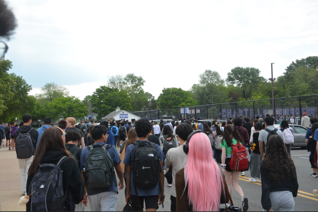 Students walk to the field after being notified to evacuate the main building.
