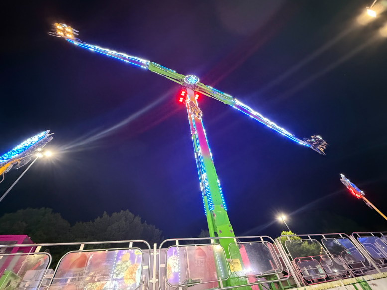 Passengers’ seats spin rapidly as the “Air Raid” ride revolves vertically through the air.
