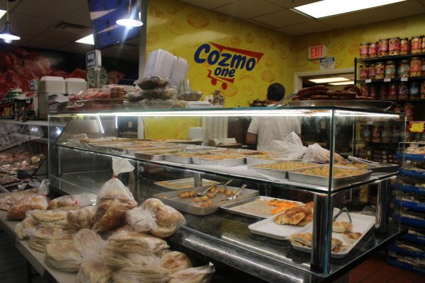 On May 4, Cozmo One’s bakery restocks prior to its most crowded time of day, afternoon tea, bringing out fresh desserts and bread to serve customers.
