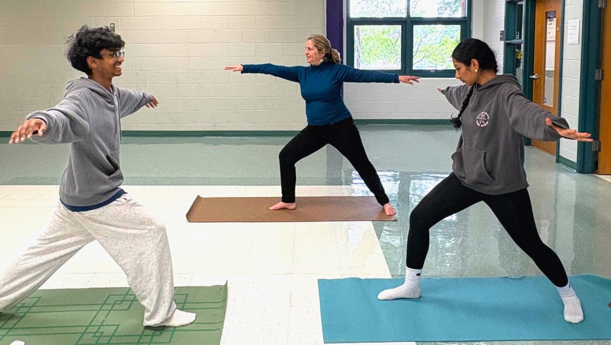 Juniors Shantanu Karthikeyan and Bhavyasri Chaluvadi practice asana (physical) poses under the guidance of Daly on April 29, focusing on balance, flexibility and mindfulness.