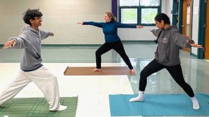 Juniors Shantanu Karthikeyan and Bhavyasri Chaluvadi practice asana (physical) poses under the guidance of Daly on April 29, focusing on balance, flexibility and mindfulness.